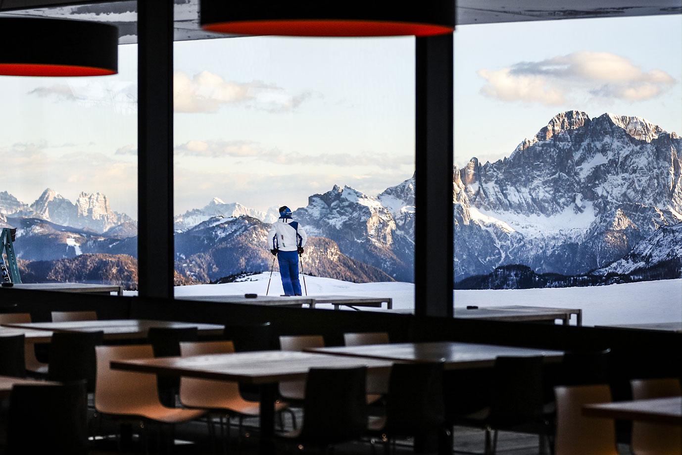 Front view of the Piz Boè kitchen where three chefs are preparing lunch to be provided to customers in the self-service area.